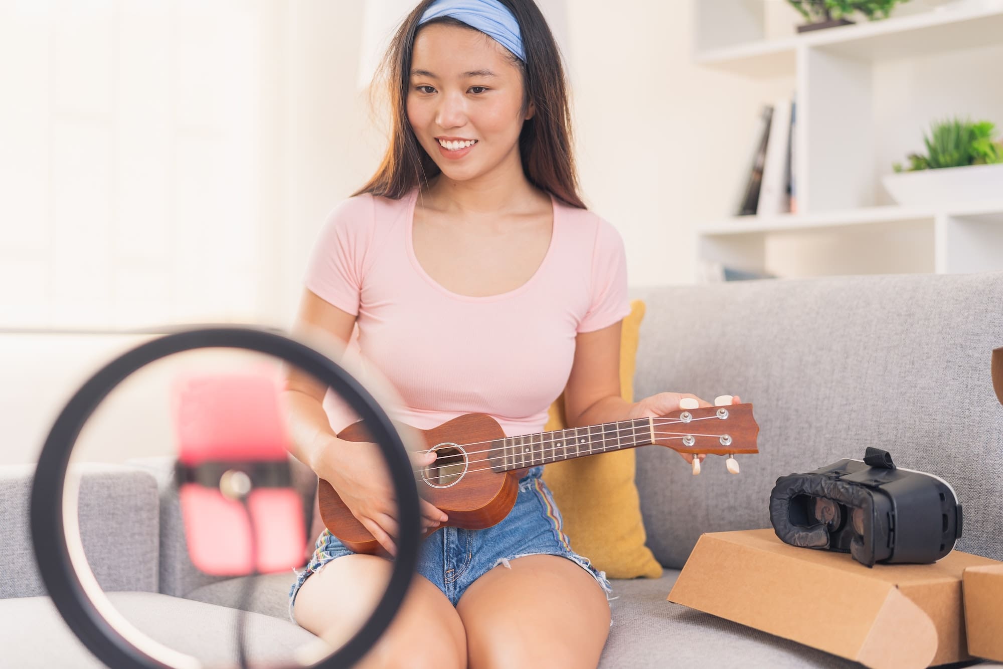 Asian influencer teaching her followers how to play ukulele