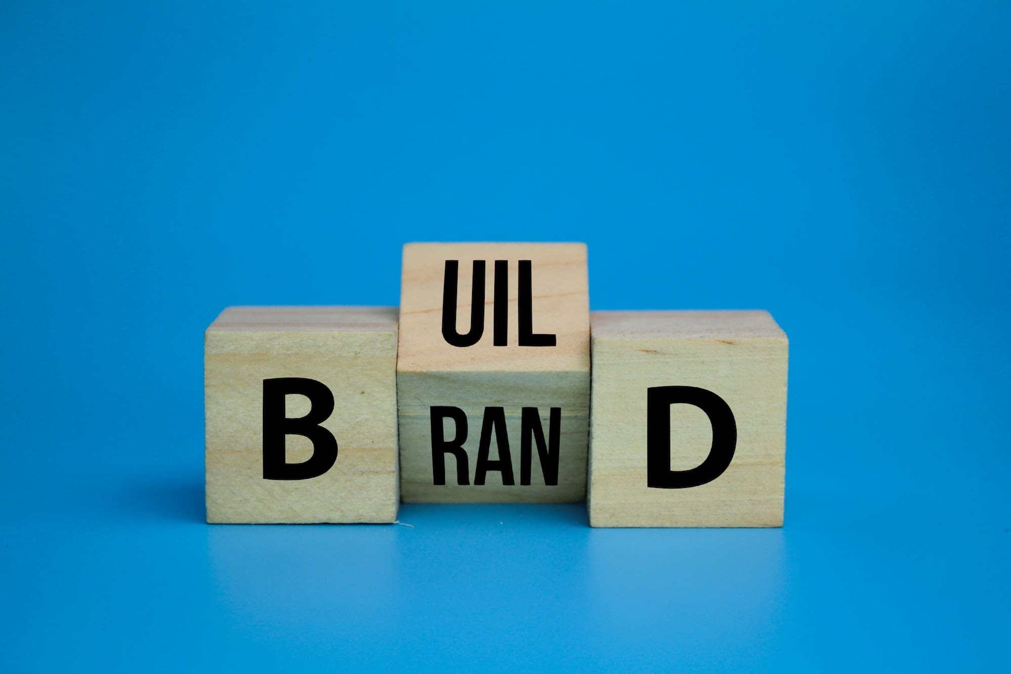 wooden cube with the word Build your brand symbol.